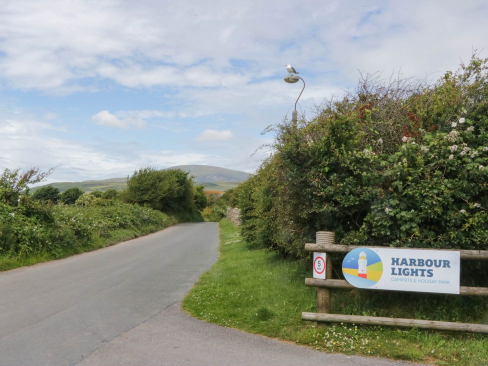 A road with a sign for Harbour Lights Campsite in Haverigg