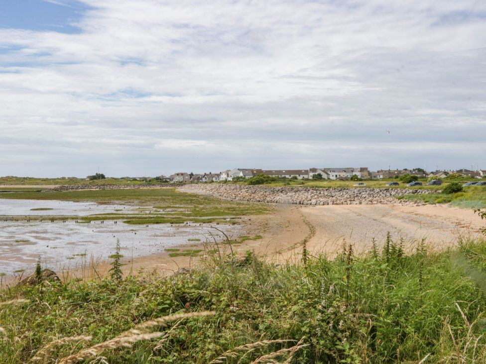 A beach with houses in the background at Heron Haverigg