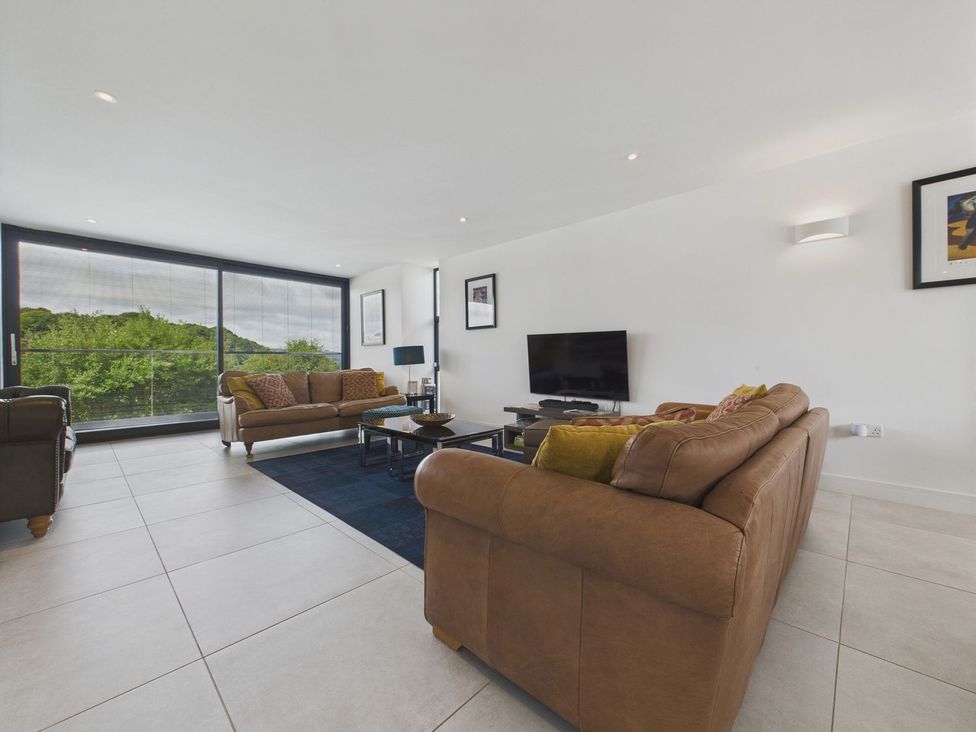 A living room with two sofas and a television at Oakwood House in Tansley near Matlock