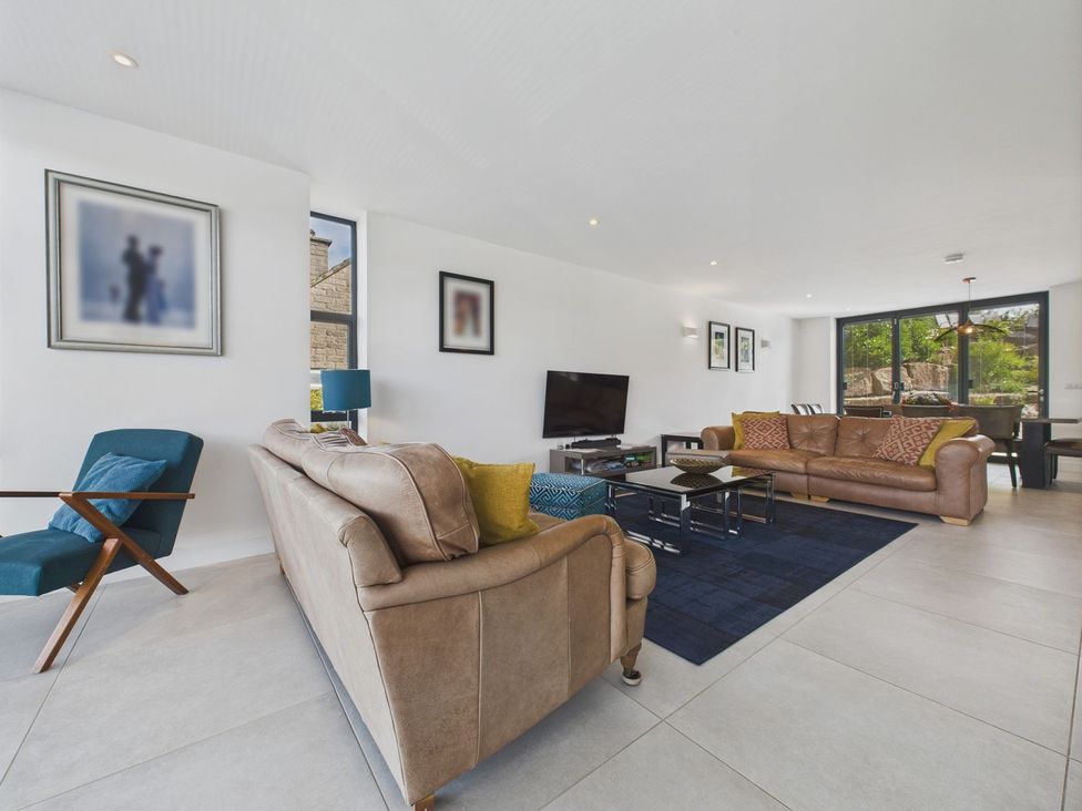 A living room with sofas and a TV at Oakwood House in Tansley near Matlock