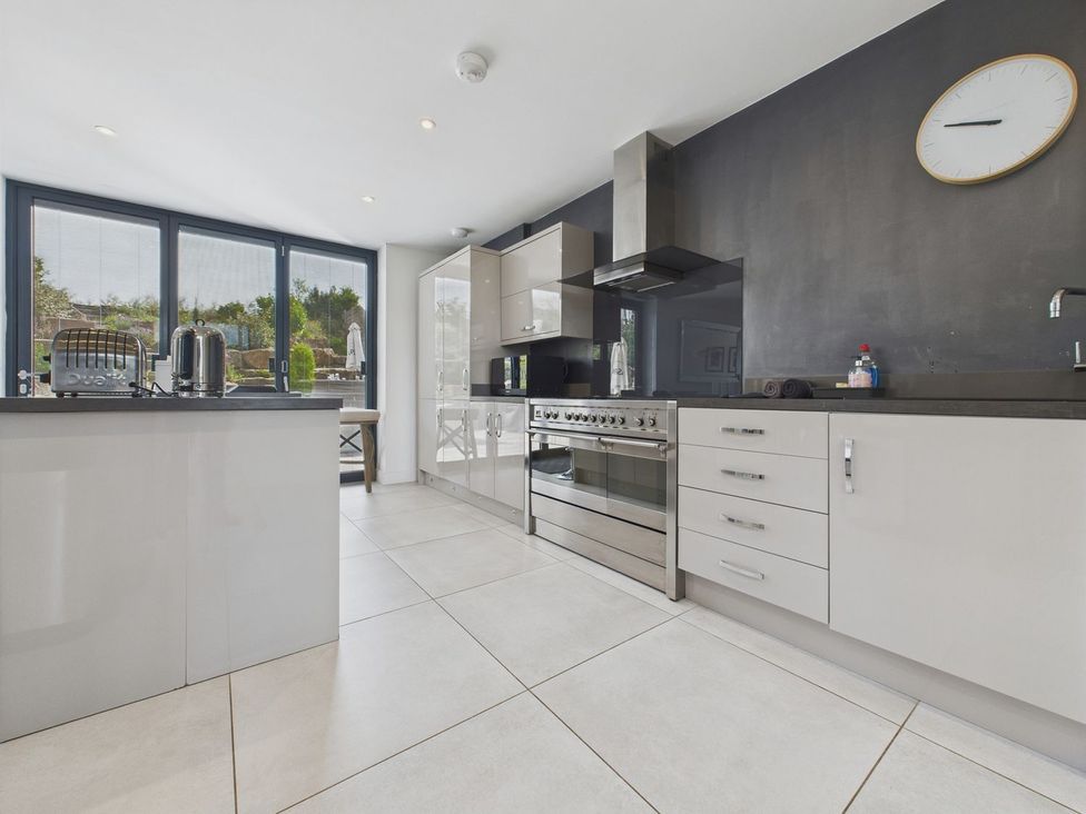 A kitchen with appliances and modern cabinetry at Oakwood House in Tansley near Matlock