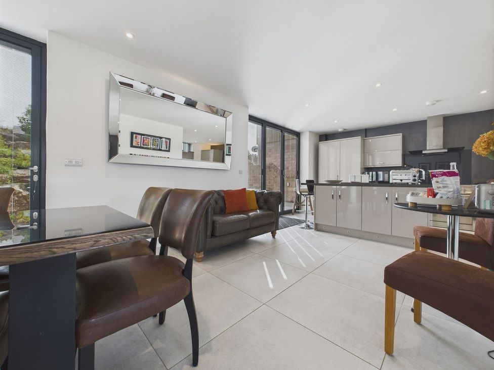 A kitchen with a dining table and chairs at Oakwood House Tansley near Matlock