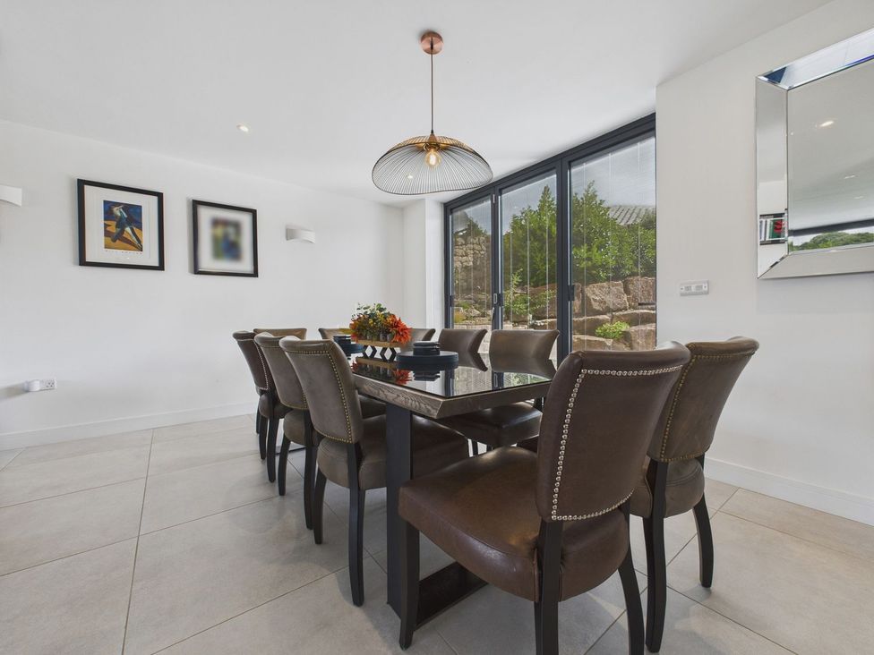 A dining room with a table and chairs at Oakwood House in Tansley near Matlock