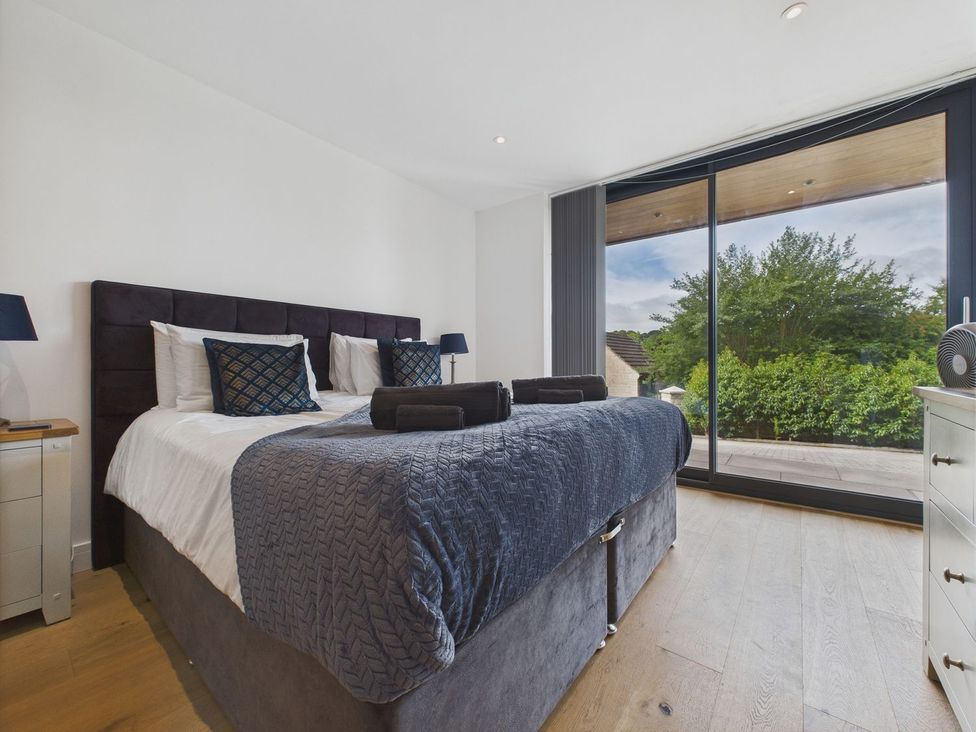 A bedroom with a bed and window at Oakwood House in Tansley near Matlock