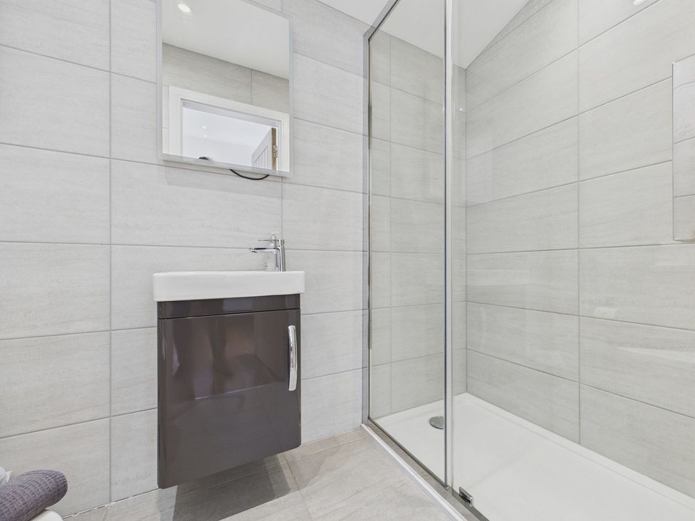 A bathroom with a shower and sink at Oakwood House Tansley near Matlock