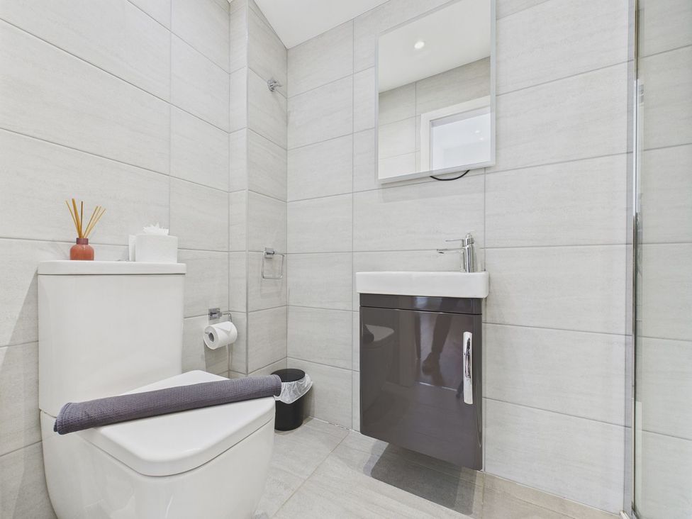 A bathroom with a sink and toilet at Oakwood House in Tansley near Matlock