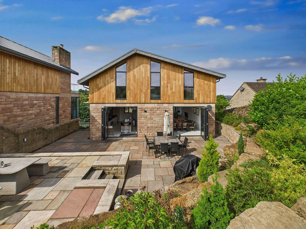 A house with an outdoor patio and furniture at Oakwood House Tansley near Matlock