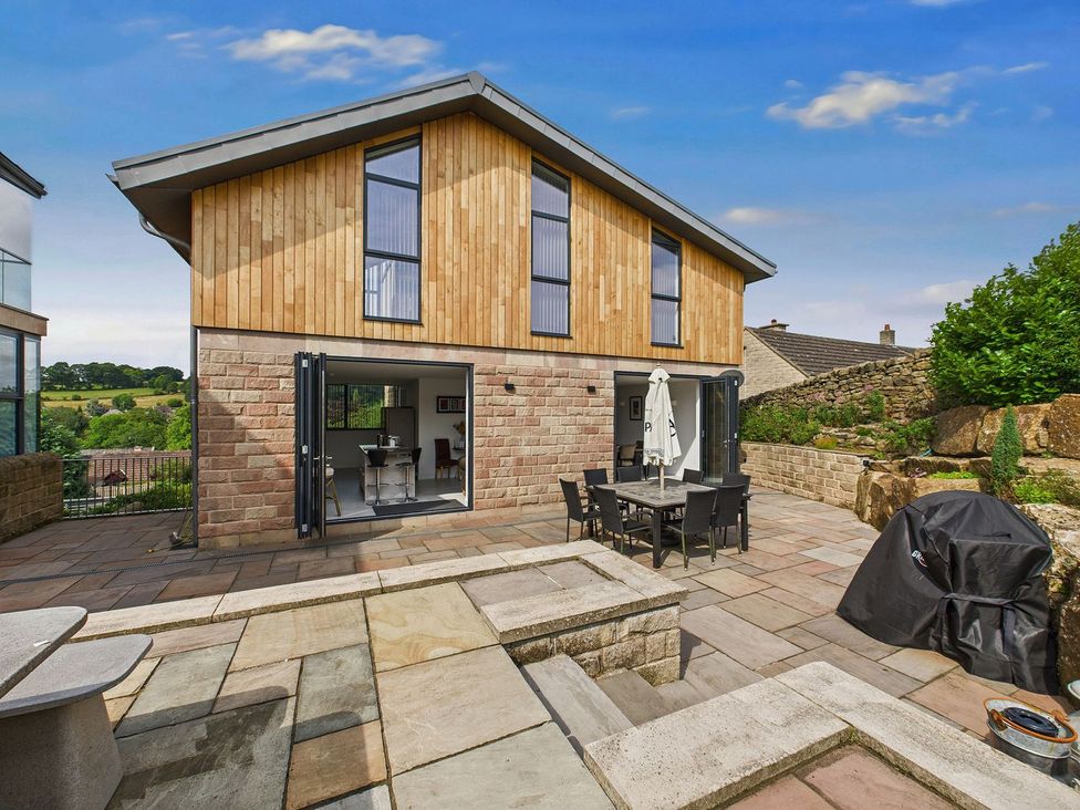 An outdoor area with patio furniture and a grill at Oakwood House Tansley near Matlock