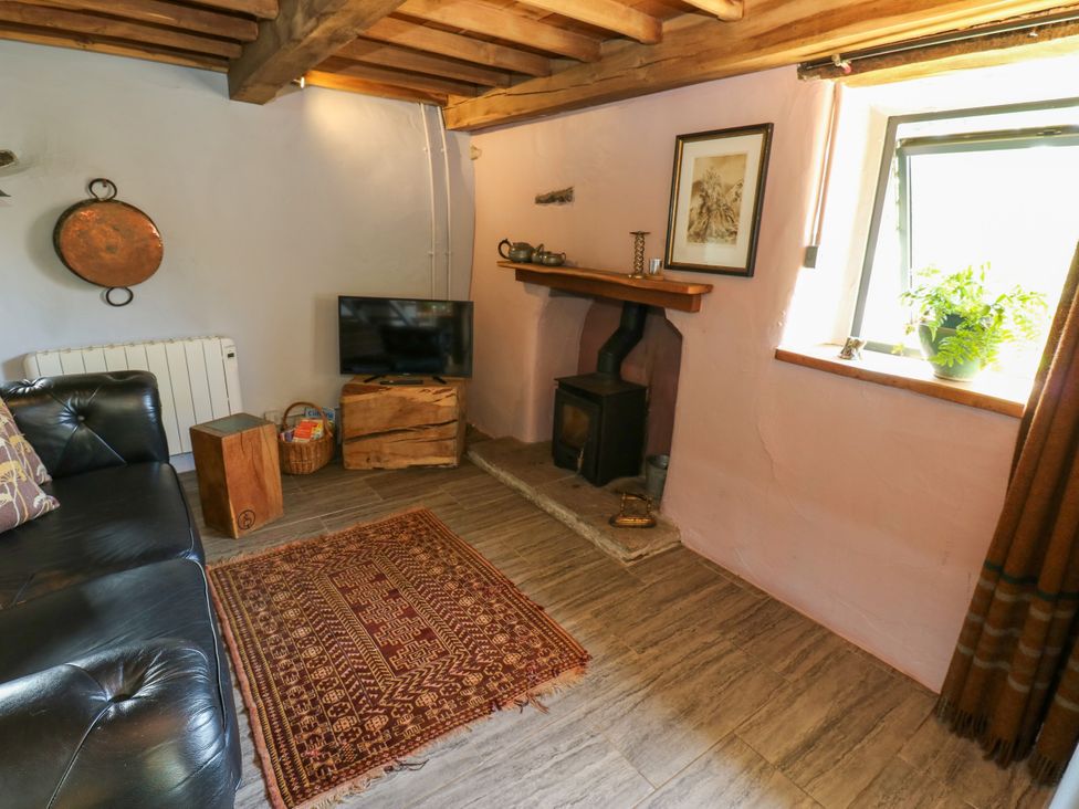 A snug with a television and wood stove at The Brew House in Penrith