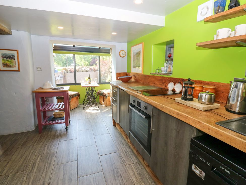 A kitchen with a window and dining area at The Brew House in Penrith