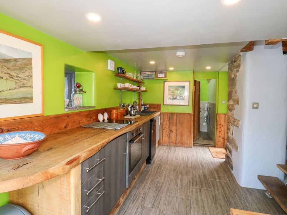 A kitchen with wooden counter and sink at The Brew House in Penrith