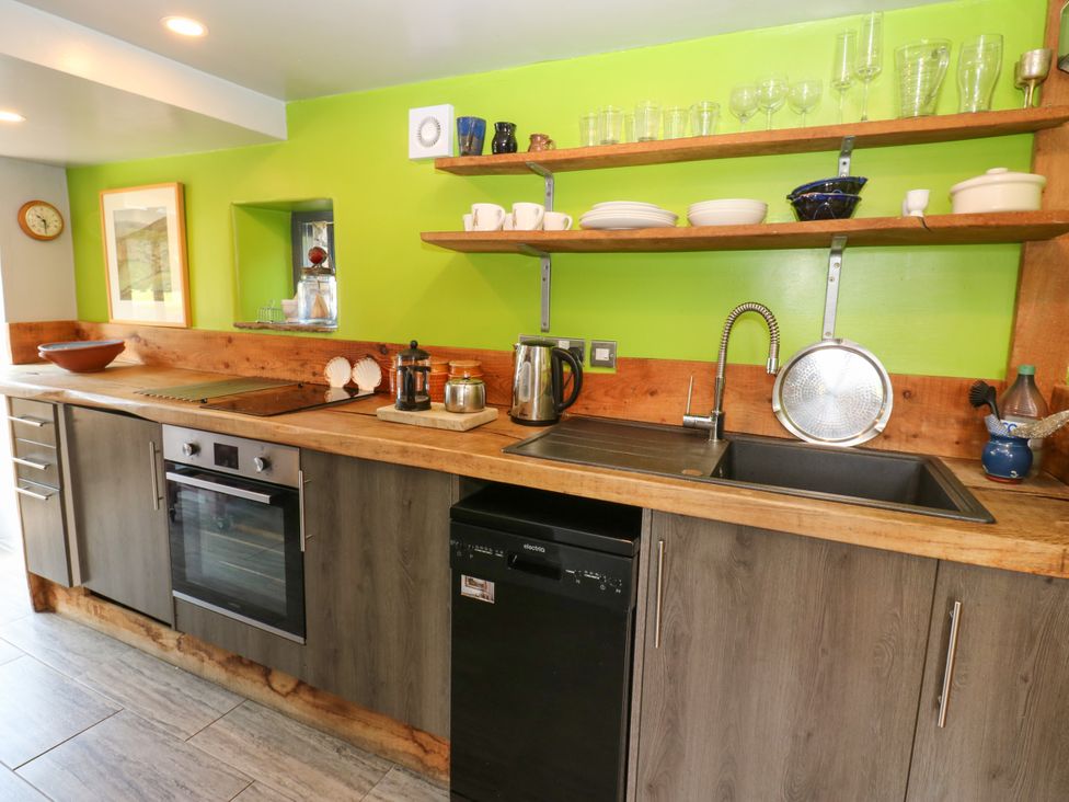 A kitchen with appliances and dishware at The Brew House in Penrith