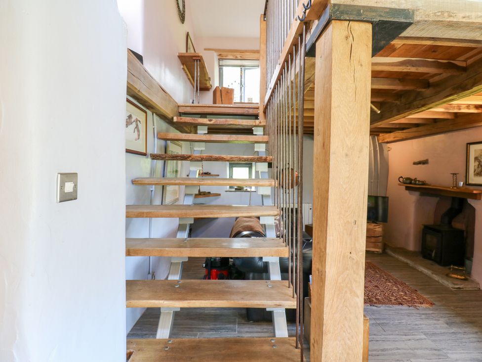 A staircase with wooden steps and railing at The Brew House in Penrith