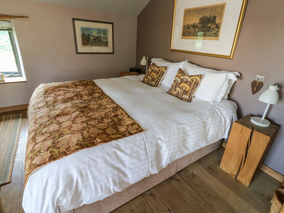 A bedroom with a bed and bedside table at The Brew House in Penrith