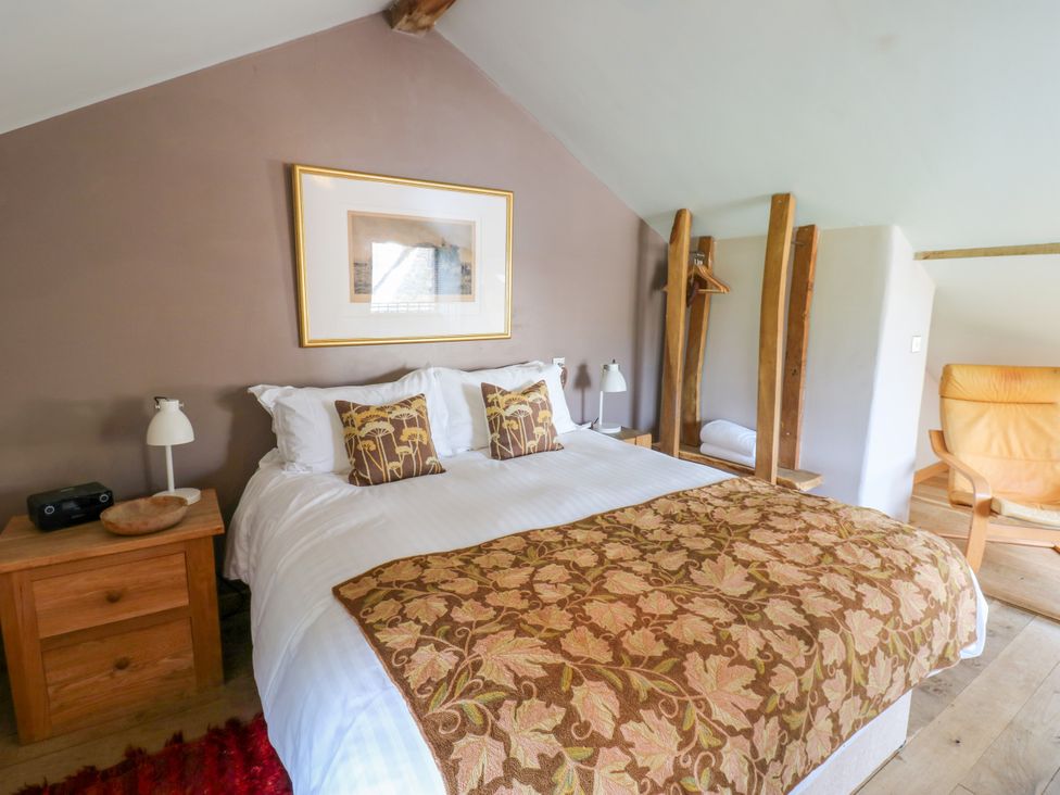 A bedroom with a bed and nightstand at The Brew House in Penrith