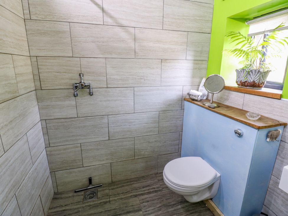 A bathroom with a toilet, sink, and shower at The Brew House in Penrith