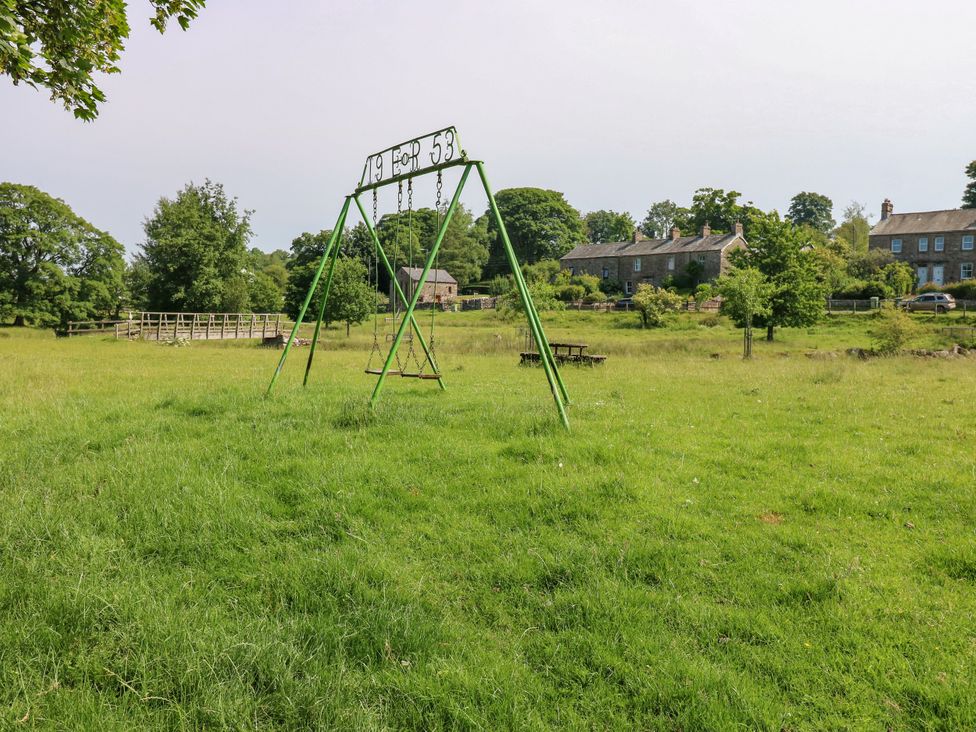 A swing set in a garden area at The Brew House in Penrith