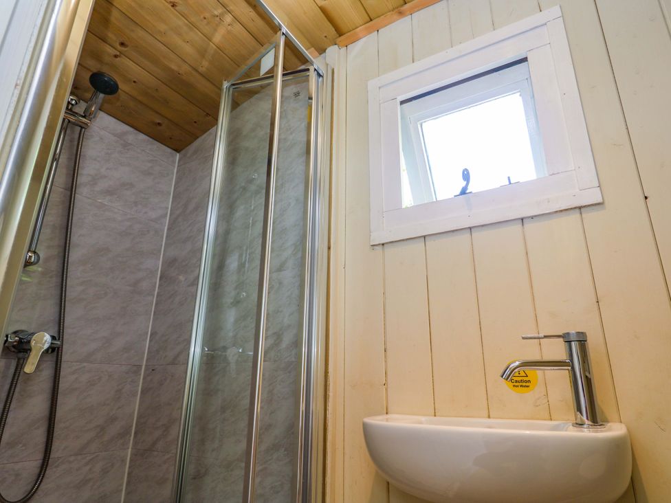 A bathroom with shower and washbasin at Shepherds Hut in Truro