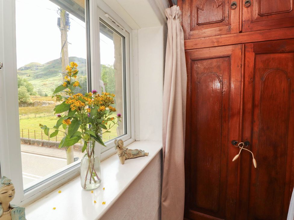 A room with a window and a wardrobe at The School House in Penrith