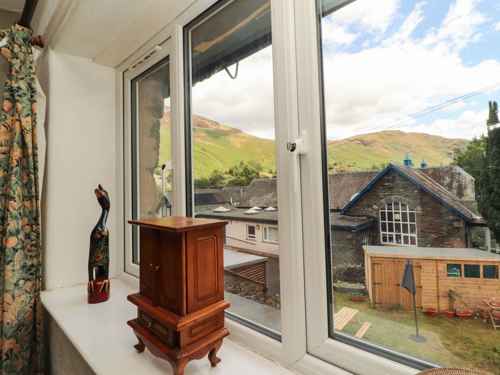 A window view with mountain landscape and garden at The School House Penrith