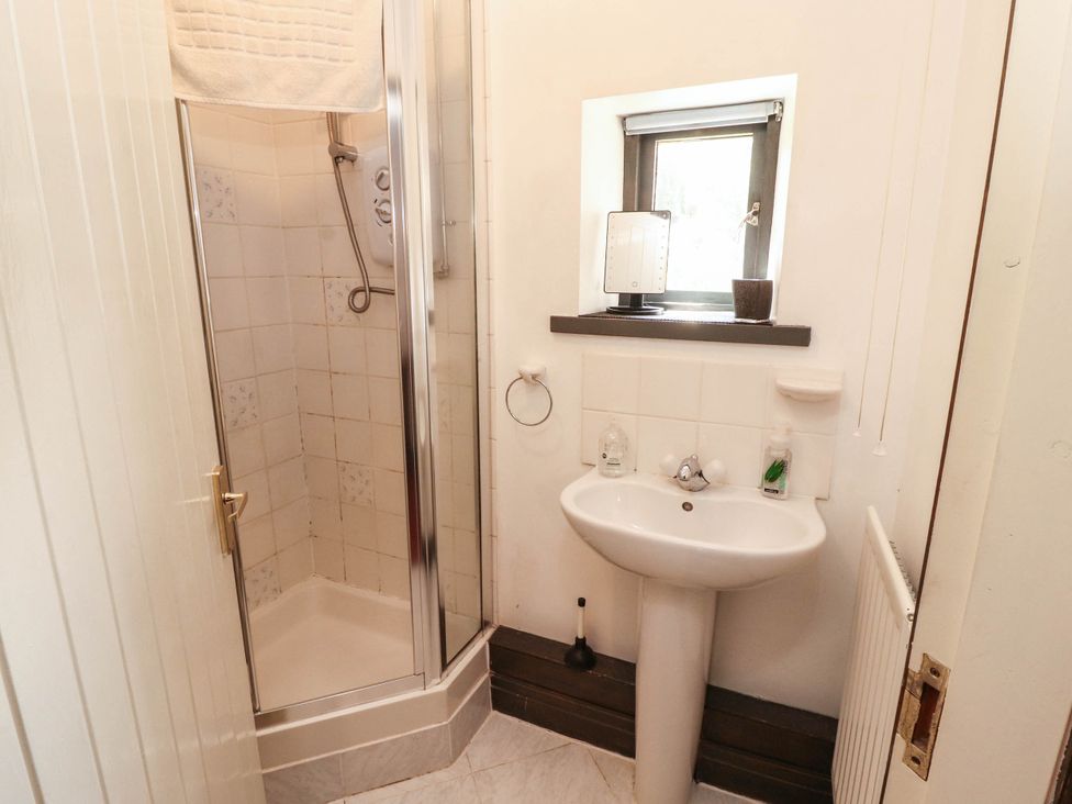 A bathroom with a shower and sink at The School House in Penrith