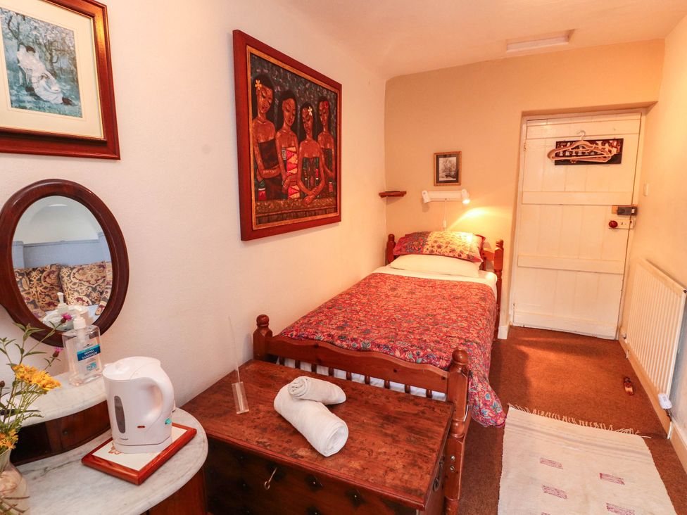 A bedroom with a bed and a kettle at The School House in Penrith