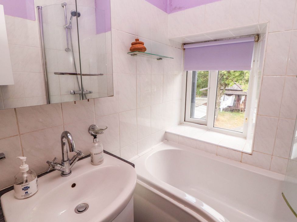 A bathroom with a bathtub and sink at The School House in Penrith