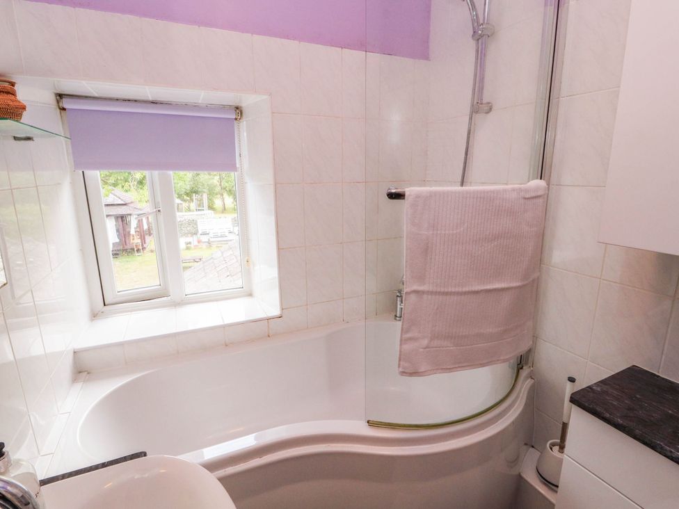A bathroom with a bathtub and shower at The School House in Penrith