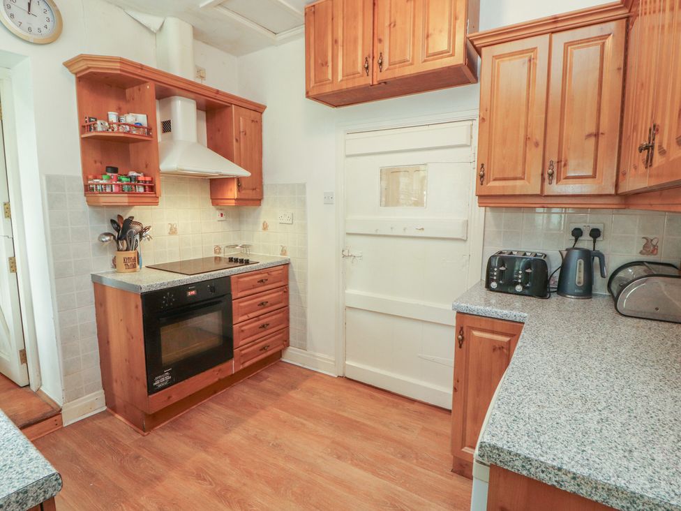 A kitchen with cabinets and appliances at The School House in Patterdale near Glenridding