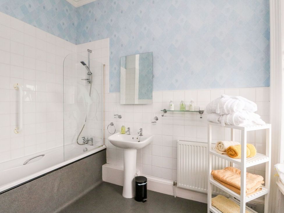 A bathroom with a bathtub and sink at Seaview Wellness Retreat Carnoustie