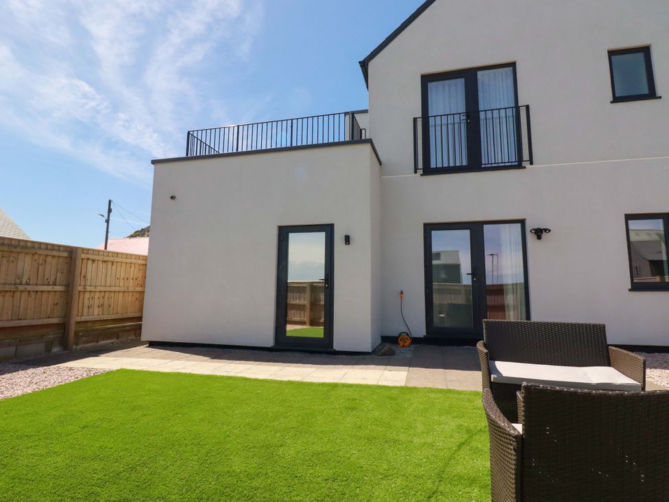 An outdoor area with grass and patio at Edens in Penwithick