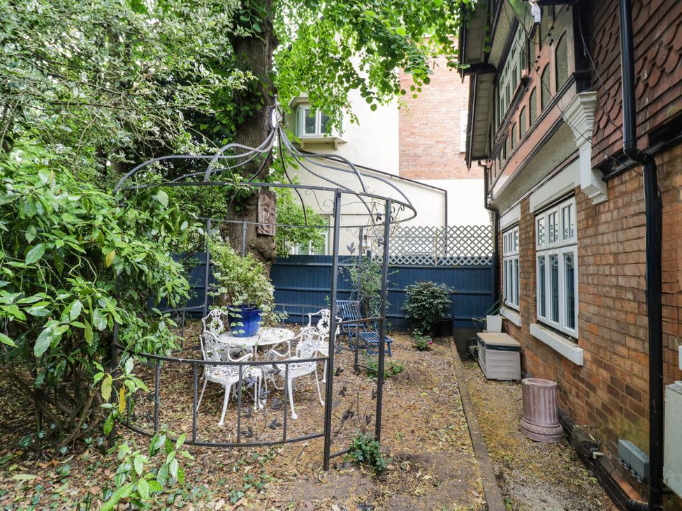 A garden with a gazebo and seating area at Tudor Lodge in Birmingham