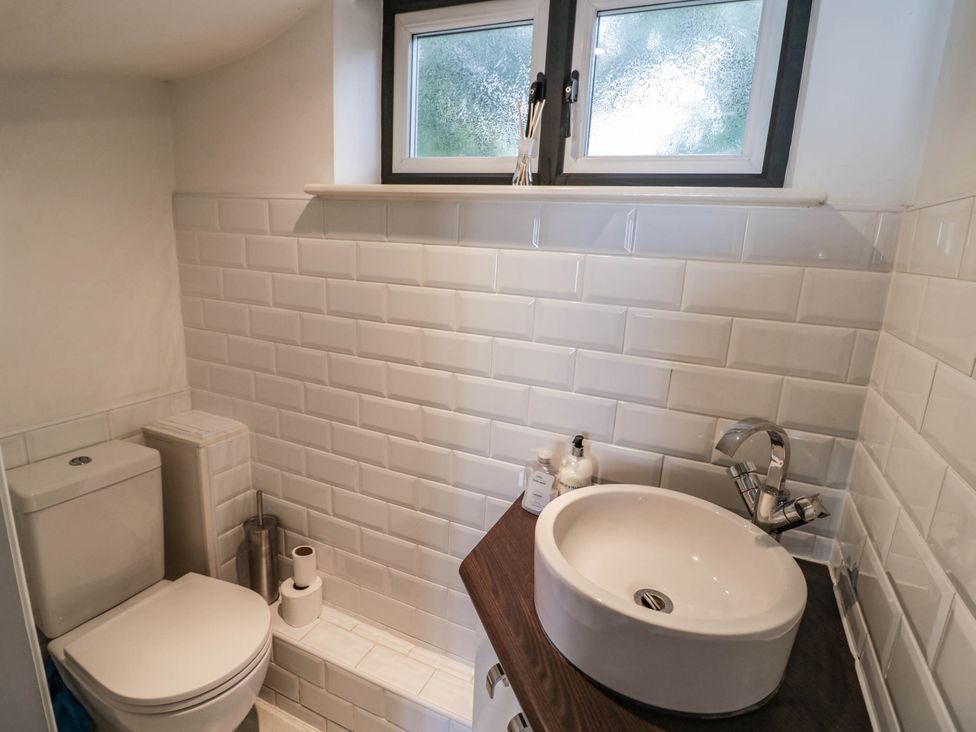 A bathroom with a toilet and sink at Tudor Lodge in Birmingham