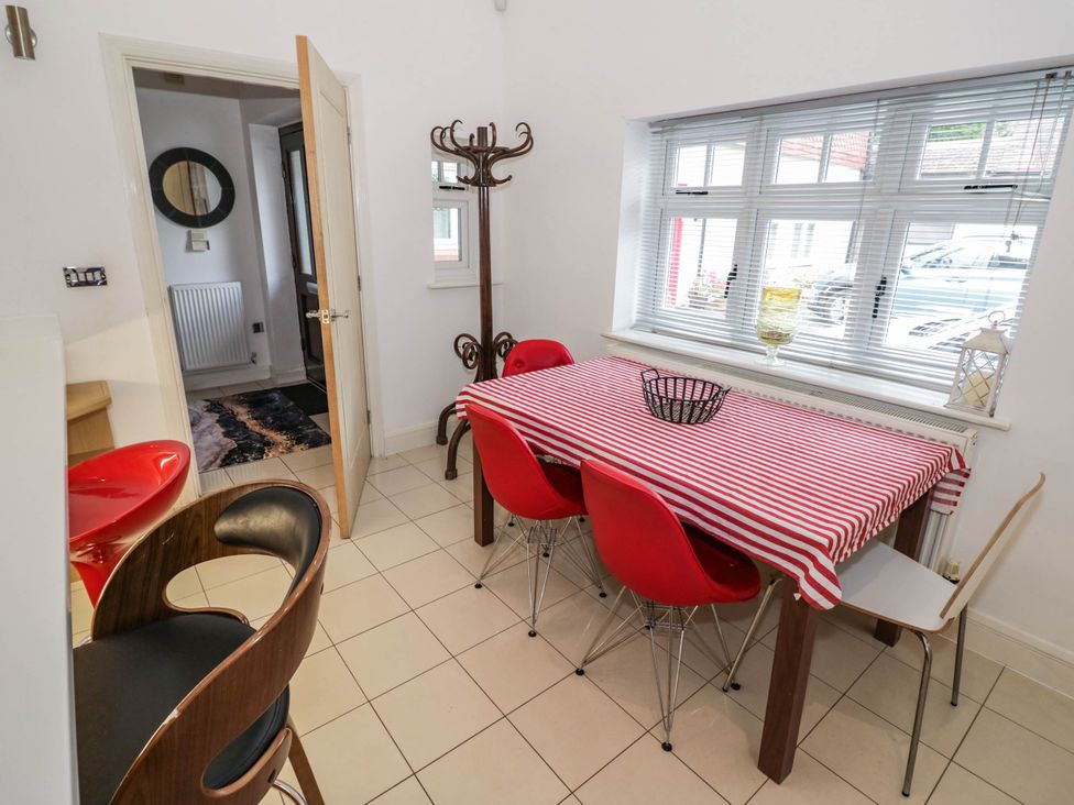 A dining room with a table and chairs at Tudor Lodge in Birmingham