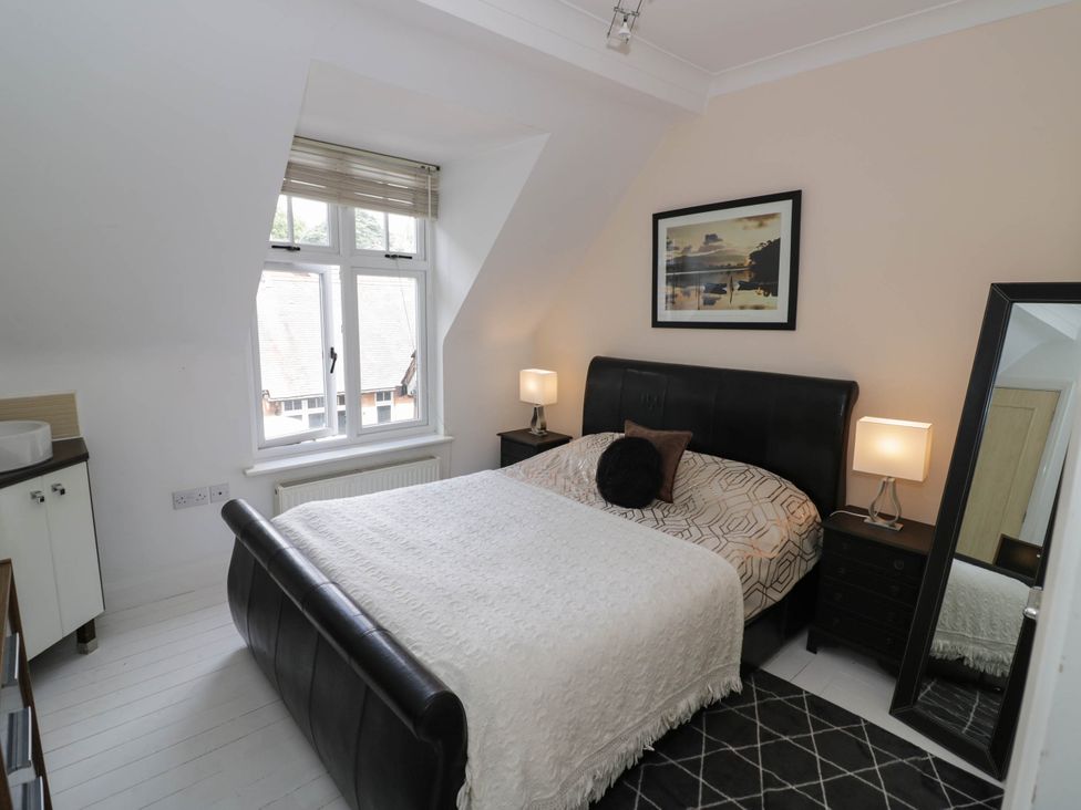 A bedroom with a bed and nightstand at Tudor Lodge in Birmingham