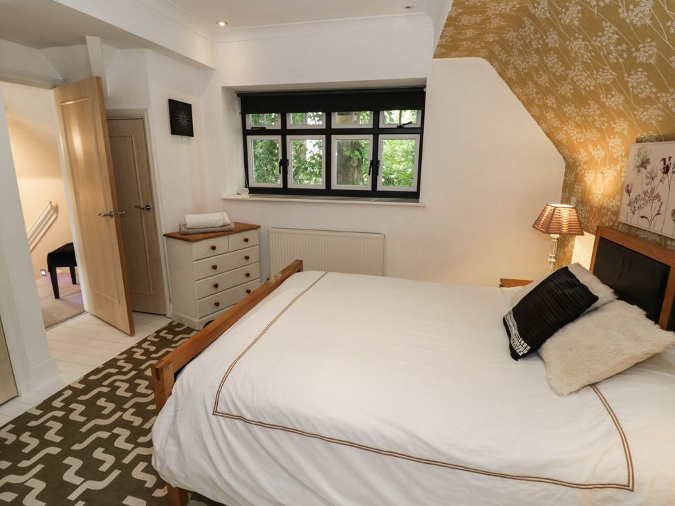 A bedroom with a bed and a window at Tudor Lodge Birmingham