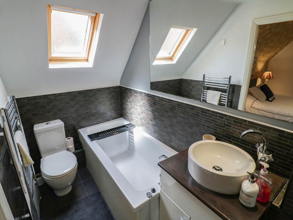 A bathroom with a bathtub and sink at Tudor Lodge in Birmingham