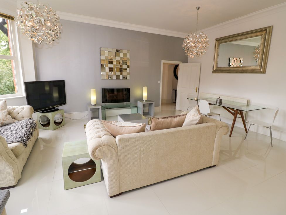 A living room with furniture including a sofa and television at Manor House in Birmingham