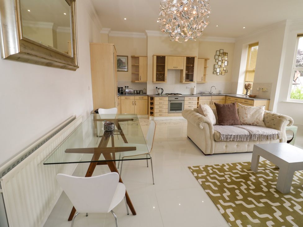 A living room with kitchen appliances and furniture at Manor House in Birmingham