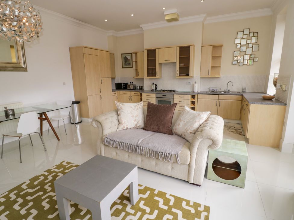 A living room with a sofa and dining area at Manor House in Birmingham