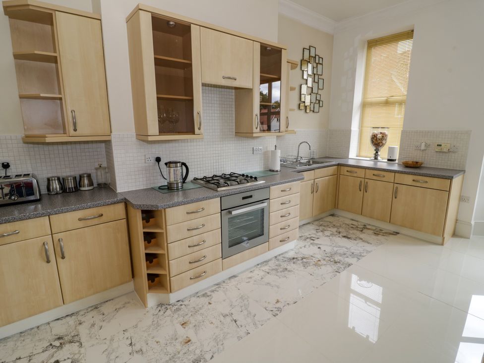 A kitchen with cabinets and appliances at Manor House in Birmingham