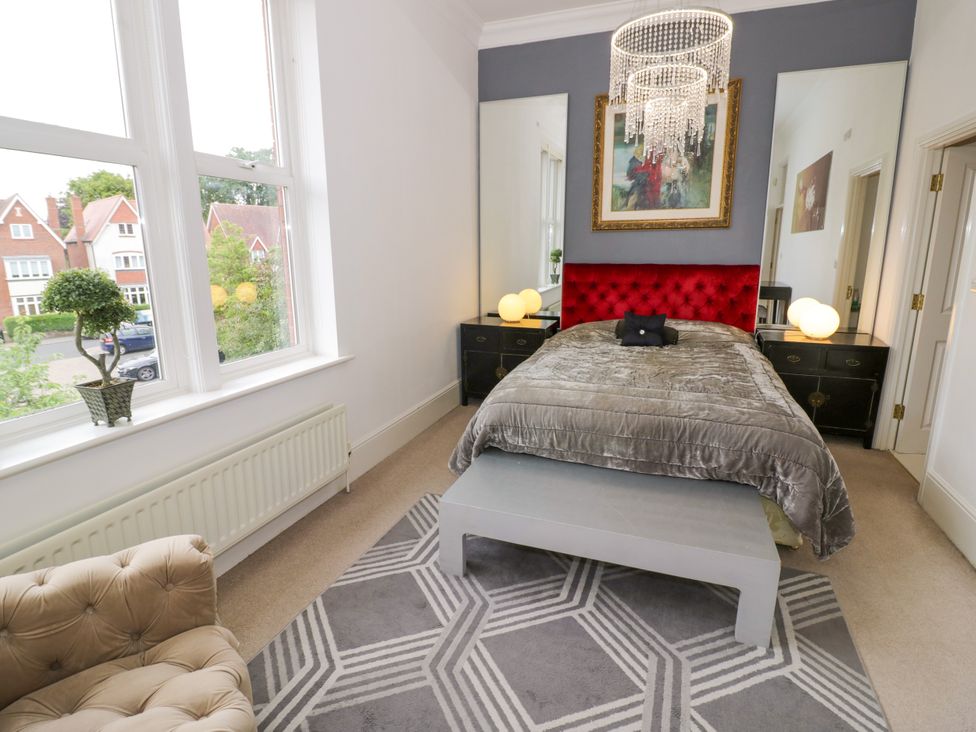 A bedroom with a bed and bedside tables at Manor House Birmingham