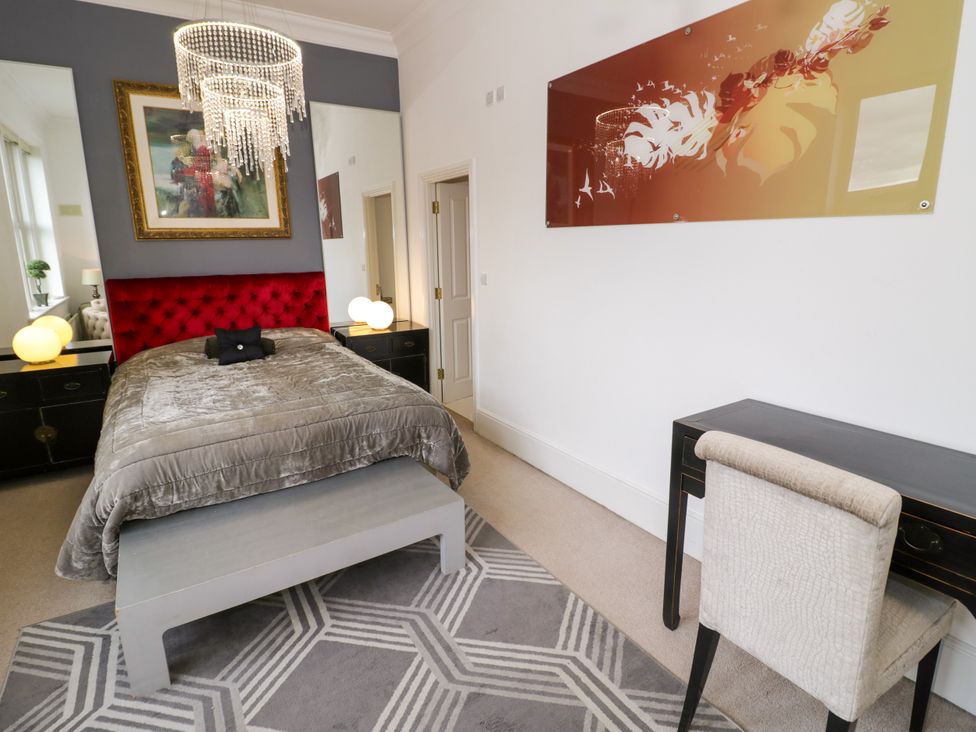 A bedroom with a bed and desk at Manor House in Birmingham