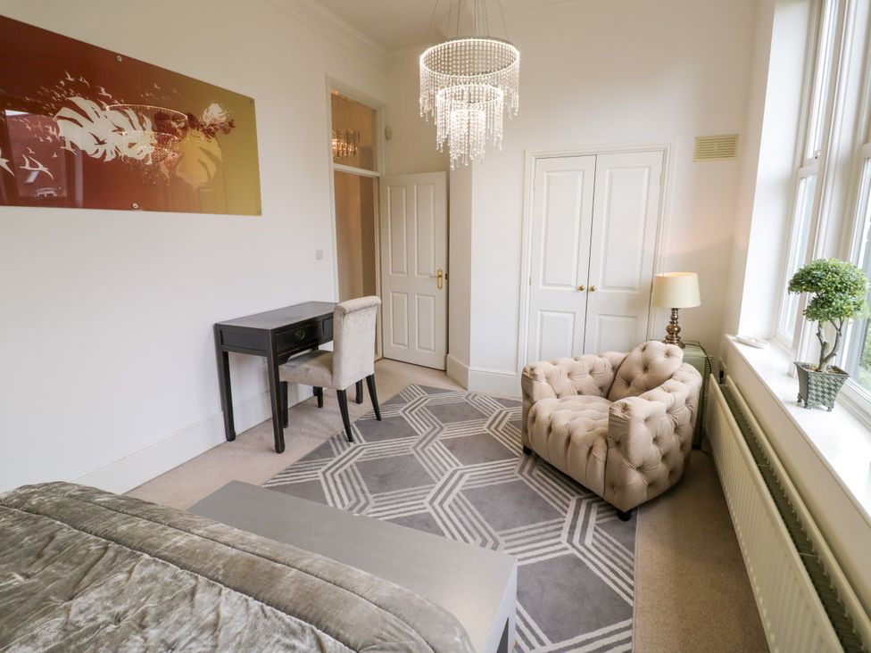A bedroom with a bed and desk at Manor House in Birmingham
