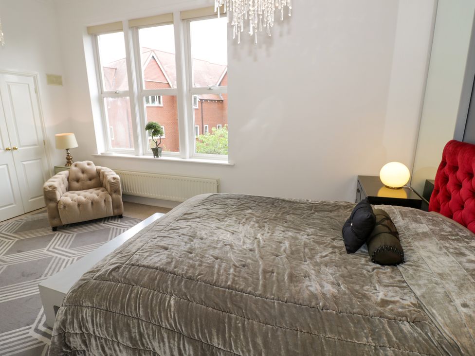 A bedroom with a bed and chair at Manor House in Birmingham