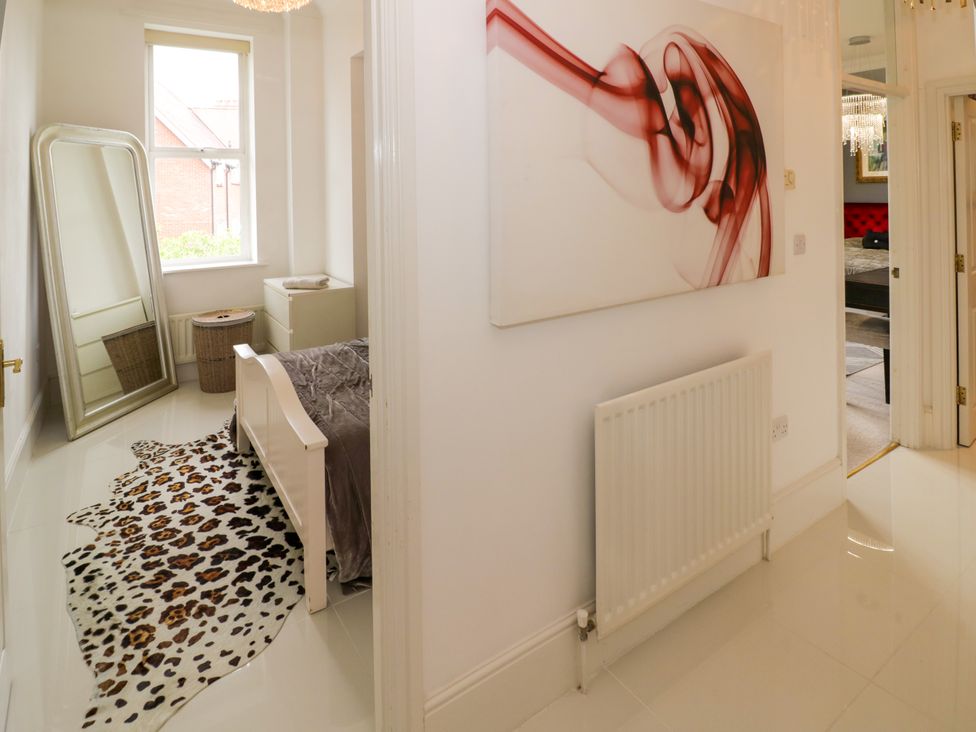 A bedroom with a bed and mirror at Manor House in Birmingham