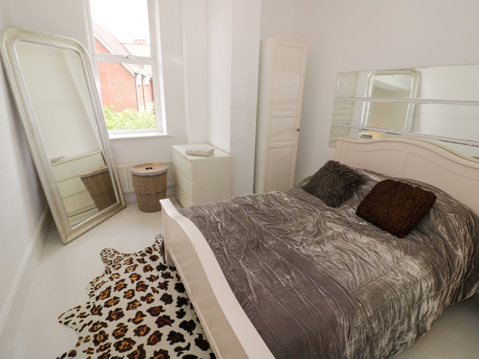 A bedroom with a bed and a mirror at Manor House in Birmingham