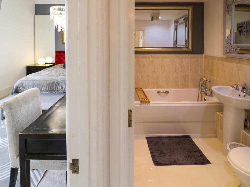 A bathroom with a sink and bathtub at Manor House in Birmingham
