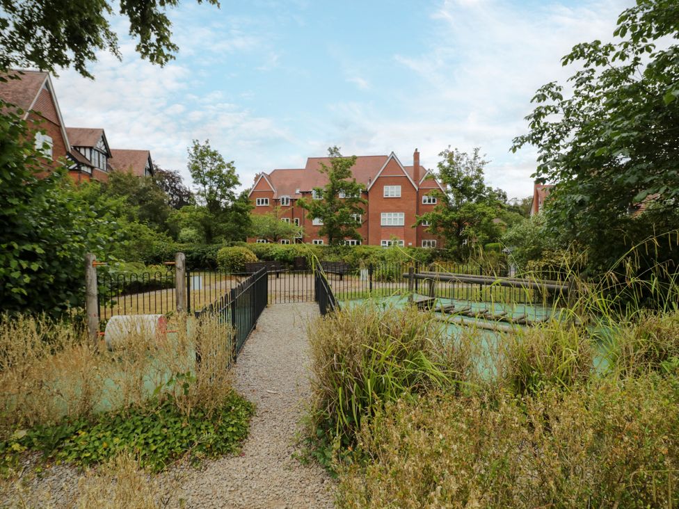 A garden with a fence and pathway at Manor House in Birmingham