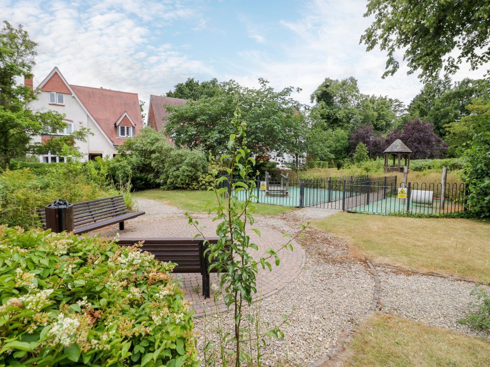 A garden area with a bench and playground at Manor House in Birmingham